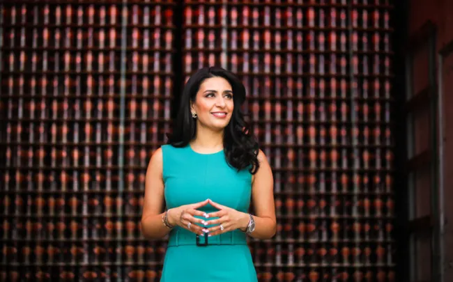 The image shows Manjit Minhas, co-owner of Minhas Craft Brewery, known for her leadership in the brewing industry. The photo is from Medium ("Manjit Minhas," n.d.).